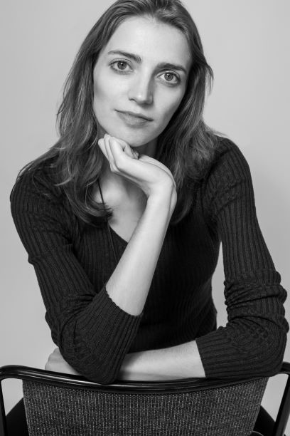 Black and white photo of a young woman looking at the camera